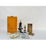 A mid 20th Century lacquered steel and cast iron Chinese microscope, model L-201 in wooden case,