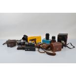 A quantity of cameras and camera accessories, including two SLR examples, one Olympus OM10 with Carl