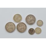 A collection of seven Georgian circulated silver coins, including two George III 1818 and 1819