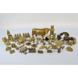 A collection of brass animal figures, including a heavy cast model of a horned cow, bear money