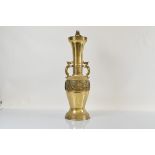 A large Chinese brass dragon twin handled lamp base, of tapered design with Greek key decoration and