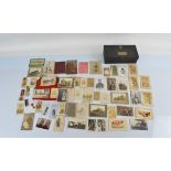 A collection of assorted early 20th century and WW1 era photographs and postcards, together with