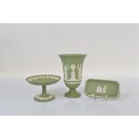 A footed green and white Wedgwood jasperware vase, with classical figures 19cm high together with