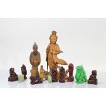 A carved soft wood Chinese figure of Guanyin, 32cm high, three other wooden carved figures and