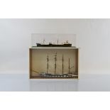 A hand painted scratch built ship model set in glass and wooden display case, together with