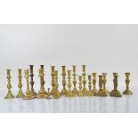Eleven pairs of brass candlesticks, various styles