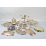 A quantity of silver plated ware, including a five branch candelabra, oval footed biscuit barrel,