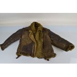 An American WWII leather and sheepskin lined flying jacket, with various home made repairs,