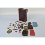 A collection of assorted badges, medallions and associated militaria, including a bronze George V