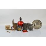 A vintage burgundy Sparklets soda syphon, together with two novelty cigarette lighters, one in the