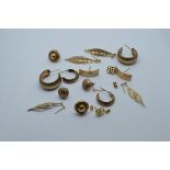 A collection of 9ct gold earrings, including a pair of leaf drops, various stud and hoop examples,