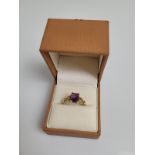 A 9ct gold amethyst dress ring, the mixed cut rectangular claw set amethyst with pierced set