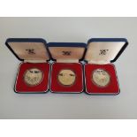 Three Royal Mint Silver Jubilee Commemorative Crowns, together with two silver proof commemorative