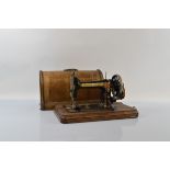 A Bradbury's 'SOEZE' table top hand crank sewing machine, number 13514, in case