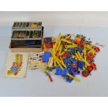 A mixed lot of unboxed Meccano parts, plastic and metal examples with some related instructions