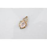 A certificated 9ct rose quartz and diamond set yellow gold pendant, the rose quartz oval mixed cut