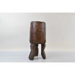 A carved African food mixing vessel, with one figural leg, 51cm high