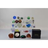 A collection of twenty nine paperweights, to include a Caithness limited Vortice, boxed, a Pearl