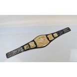 A WWE Commemorative signed spinner Champ belt, the black leather with applied gold plated and silver