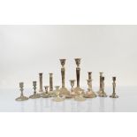 A collection of silver plated candlesticks, including eight pairs of various forms, tapered,