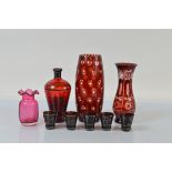 A Bohemian cranberry glass liquor set, comprising decanter and five conical beakers with silvered