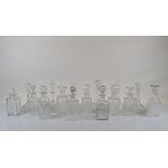 A very large collection of glass decanters and associated stoppers, including ships, square,