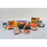 A collection of car and engine parts, including spark plugs, filters, electrical units, battery