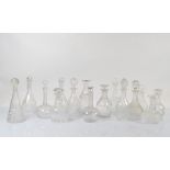 A collection of cut glass decanters with associated stoppers, of mallet and bulbous form (a