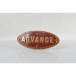 A brass and enamel oval lorry plate, mounted on mahogany stand, 'Advance' 40cm x 17cm