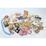 A collection of costume jewels, including a tiger's eye pendant, Scottish brooch and matching