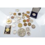 A collection of commemorative silver and base metal coins and medallions, including a Danbury mint