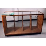 A counter display cabinet, with four banks of tapering glass shelves, no doors to back, 153cm x 91cm