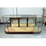 A large cabinet display case, with curved ends, with two long row of glass shelving made up on
