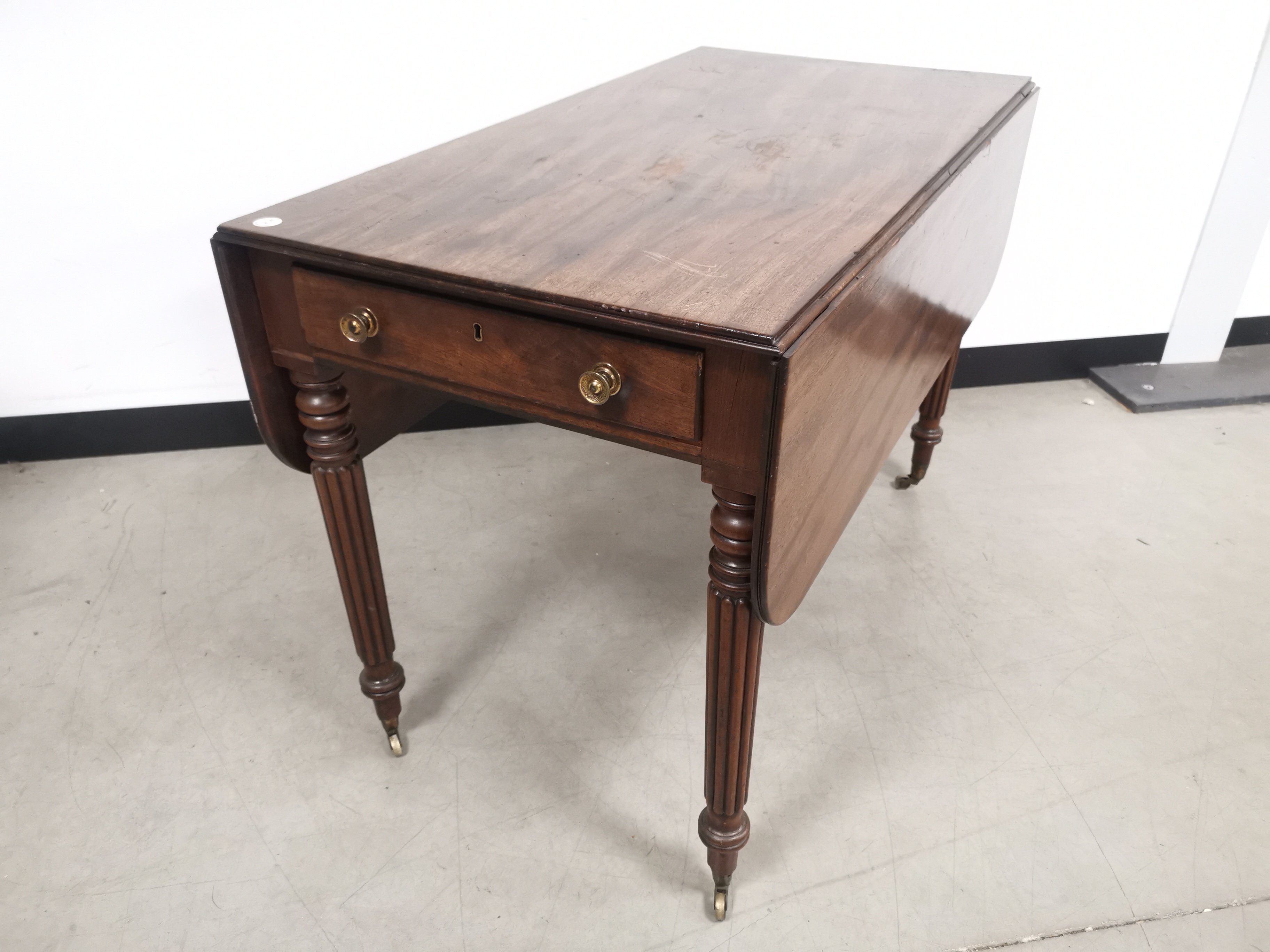 Mahgonay drop leaf table, Reed supports set on castors, drawer to one end, dummy drawer to the