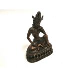 A cross legged South East Asian metalwork figure, seated on a lotus base, height 19cm