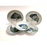 A group of porcelain dishes for the Japanese market with central designs of fish, the two largest