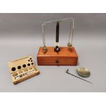 A portable cased set of scales, together with a boxed selection of weights.