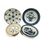 A group of four Asian provincial kiln plates one with a design of an ornamental flower display,
