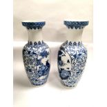 A pair of blue an white Asian floor vases of substantial proportions, with central cartouches of