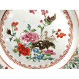 A Chinese 18th Century polychrome enamel export plate with an insect resting on a flower head,
