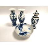 A pair of Chinese porcelain vases with underglaze blue decoration of birds amidst plant life, with