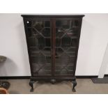 Glazed two door cabinet, Sat on base, raised on claw and ball supports. 96cm W x 157cm H x 36cm D