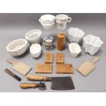 An assortment of kitchenalia, to include jelly moulds, utensils and scales.