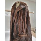 A full length mink fur coat, dating to the early to mid 20th Century, with embroidered initials,