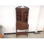 Mahogany glazed curio display cabinet, carved decoration to the two drawer fronts, two internal