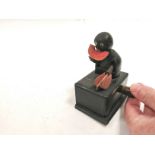 A novelty early 20th Century treen toy automaton of a bald headed figure chopping and munching on