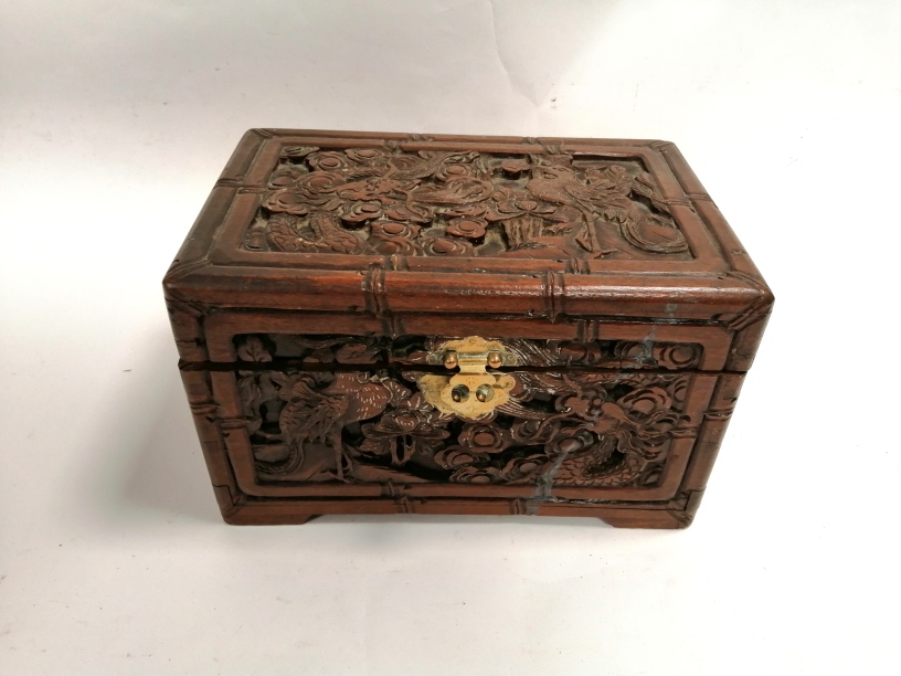 A table top camphor wood chest, with a carved phoenix and dragon design, 19cm x 30cm x 20cm