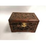 A table top camphor wood chest, with a carved phoenix and dragon design, 19cm x 30cm x 20cm