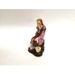 A Chinese Peoples Republic figure of an elder, with overglaze polychrome enamelling and café au lait