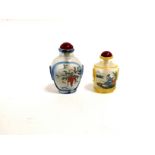 A Chinese glass snuff bottle with a panel of fishermen in a boat and to the verso goldfish, together